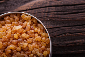 frankincense essential oil on a wooden background