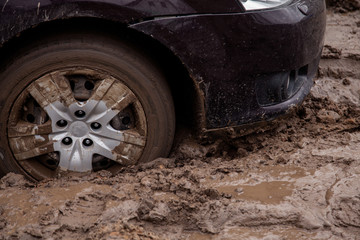 the car is stuck on a bad road in the mud