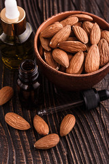almond essential oil on a wooden background