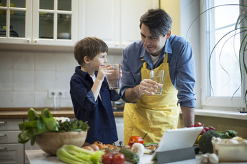 Father and son cooking in kitchen