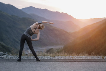 Athlete at the top of the mountain doing workout.