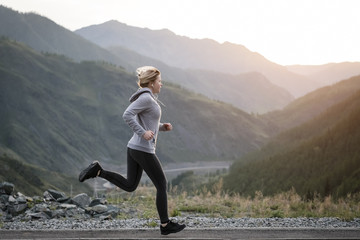 Shot of a beautiful adult woman training at sunrise.