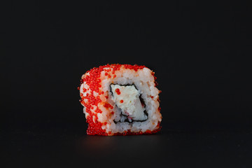 one small red crab Japanese roll on a dark background © oksanastepanova