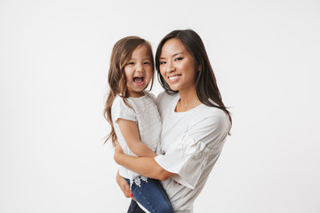 Happy young asian woman mother with her little daughter