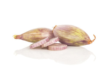 Two peeled shallots and three ring slices isolated on white background.