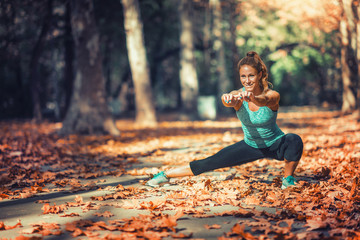 Woman Exercising Outdoors in The Fall © Microgen