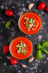 Italian red tomato cold gazpacho soup in glass, with cucumber, onion, Basil