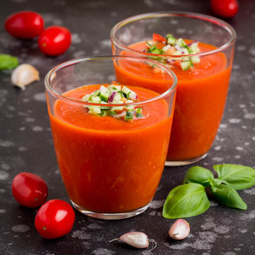 Italian red tomato cold gazpacho soup in glass, with cucumber, onion, Basil
