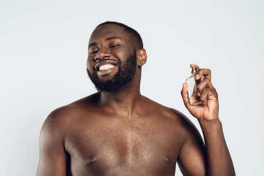 African American Handsome Man Uses Cologne.