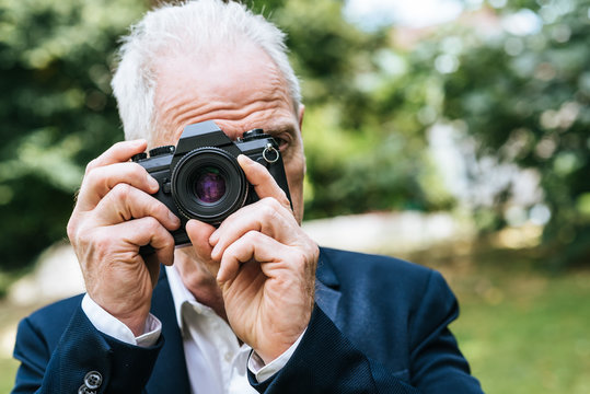 Mature man taking pictures