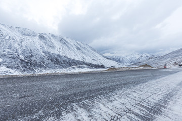 empty road through snow mountain