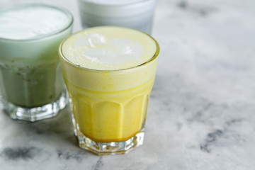 Selection of colorful super lattes on marble background