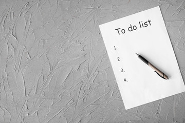 Empty to do list and pen on textured background