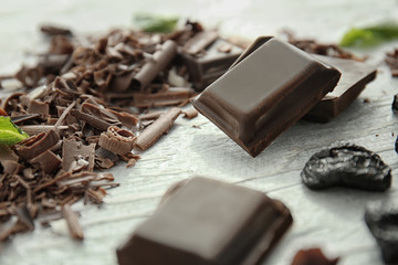 Delicious chocolate and shavings on table, closeup