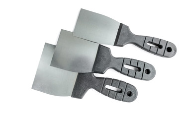 Putty knives isolated on white background. Spatula repair tool. Spackling or paint instruments.