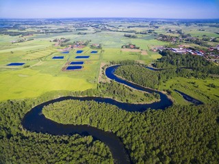 Meander of Wegorapa river flowing across wetlands, Mazury, Poland