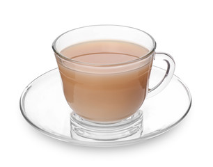 Glass cup of aromatic tea with milk on white background