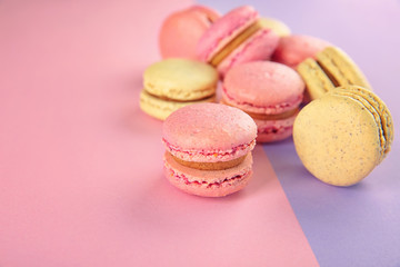 Delicious macarons on color background