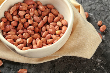 Bowl with peanuts on table