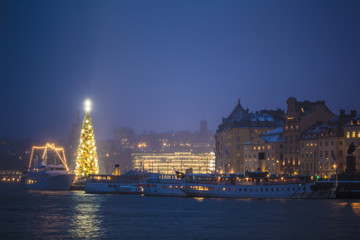 Beautiful winter scenery panorama of the Old Town (Gamla Stan) pier architecture with decorated...