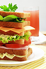 Natural sandwich and strawberry juice on wooden background