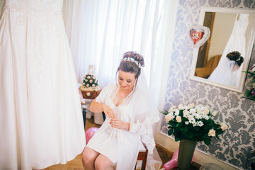 Wedding help. Hands of bridesmaids on bridal dress. Happy marriage and bride at wedding day...