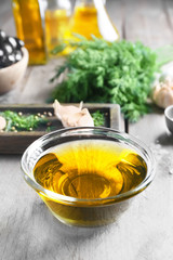 Bowl with olive oil on wooden table