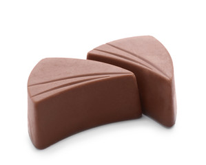 Tasty milk chocolate candies on white background