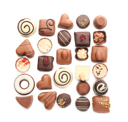 Tasty chocolate candies on white background, flat lay