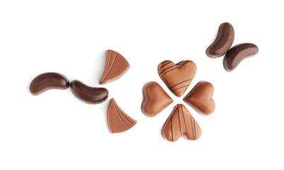 Beautiful composition with tasty chocolate candies on white background, flat lay