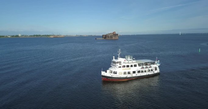 Aerial view of a small white passenger ship going along the Finnish Gulf