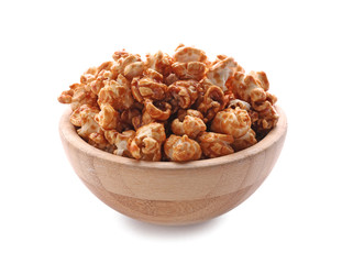 Bowl of delicious popcorn with caramel on white background