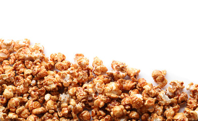 Delicious popcorn with caramel on white background