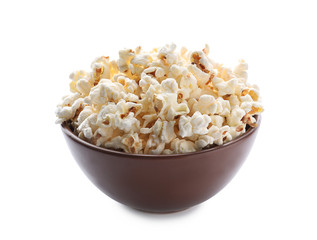 Bowl of delicious popcorn on white background