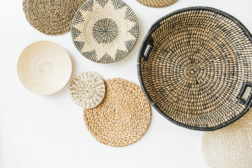 Decorative straw plates on white wall. © Floral Deco
