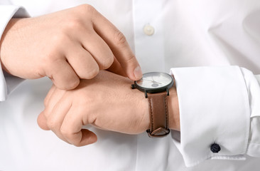 Man looking at his watch, closeup. Time management concept