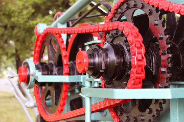 Power unit with wheels, flywheels and chain. Agricultural mechanism for harvest processing. Heavy engineering. Metal construction. Relief of manual labor. History of mechanization technologies.