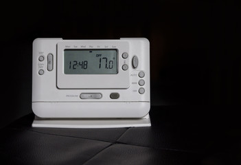 Fototapeta premium Home radio-controlled thermostat isolated on black.