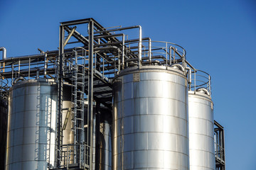 Silver wine Silos with blue sky in background