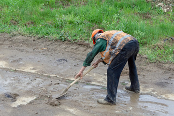 worker cleans the road