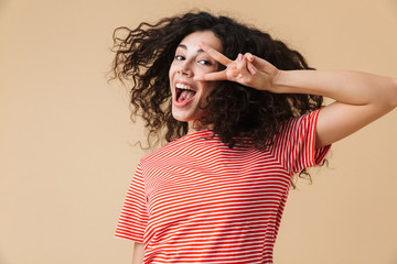 Happy pretty young woman showing peace gesture.