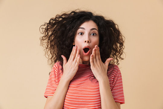 Excited shocked young woman isolated