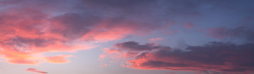 Naklejka na ściany i meble Dramatic colorful dawn/dusk sky, with dark clouds, panorama background.