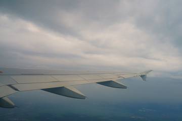 Fototapeta premium Wing of aircraft over the clouds