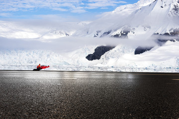 empty asphalt road with snow mountain