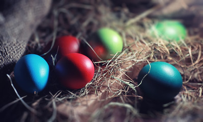 Fototapeta na wymiar Easter painted eggs on burlap