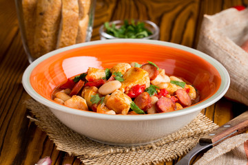 Stew with chicken, sausages, beans, tomatoes, homemade autumn dish