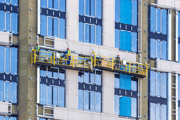 building facade cradle with workers