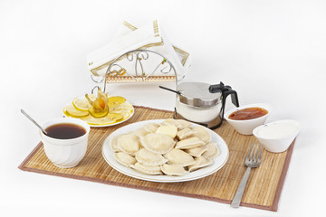 Vareniki with cottage cheese for tea. A perfect addition to the vareniki will be sour cream and a cool sweet jam.