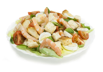 Shrimp salad with lettuce, arugula, quail eggs, cherry tomatoes, olive oil and balsamic vinegar. Caesar salad with shrimp. Isolated background.